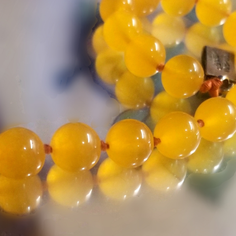 A strand of natural yellow carnelian beaded necklace with a large sterling clasp